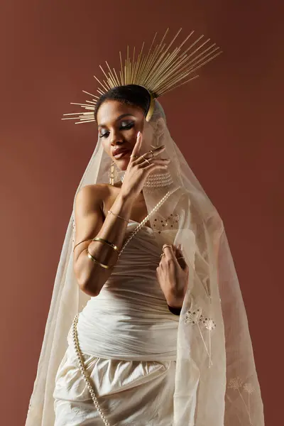 A stunning African American woman embodies grace in a white dress, adorned with pearls and delicate accessories. — Stock Photo