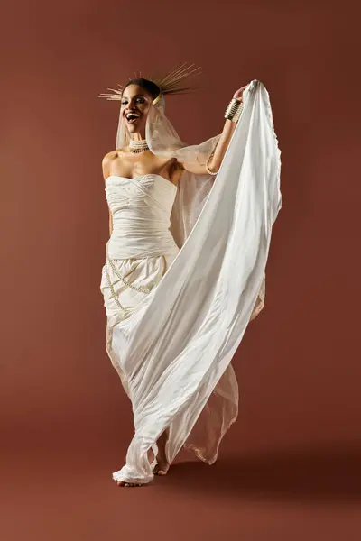 An elegant African American woman showcases grace in a white dress and pearl necklace against a brown backdrop. — Stock Photo