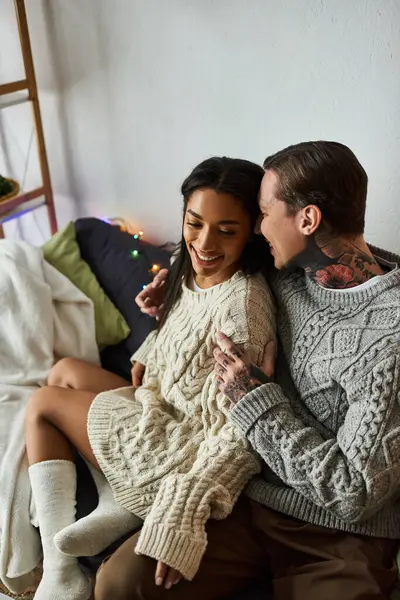 The couple enjoys a warm and intimate moment together by the festive decorations at home — Stock Photo