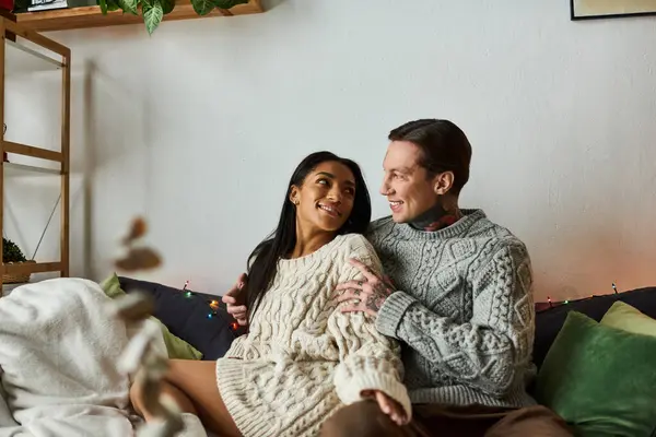 A couple enjoys tender moments together, wrapped in warmth and holiday spirit at home. — Stock Photo