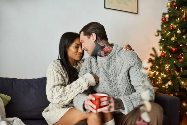 A couple enjoys a tender moment at home, surrounded by festive decorations during Christmas time. — Stock Photo