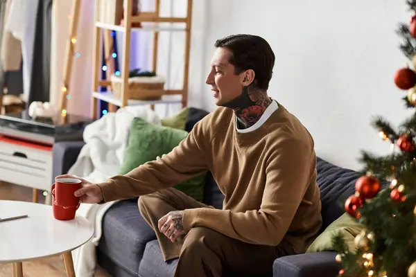 A handsome man relaxes at home, during the festive season. — Stock Photo