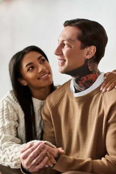 A loving couple enjoys each others company in a cozy setting filled with Christmas cheer. — Stock Photo