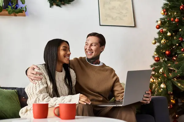 A couple enjoys each others company at home celebrating Christmas with festive cheer and warmth. — Stock Photo