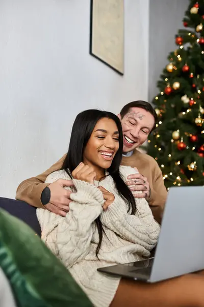 A loving couple celebrates the warmth of Christmas at home, enjoying each other. — Stock Photo