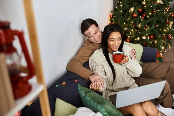 A couple shares joy and warmth while relaxing at home during the Christmas festivities. — Stock Photo
