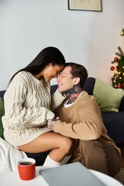 A couple enjoys sweet moments together, surrounded by Christmas decorations, warmth, and joy. — Stock Photo