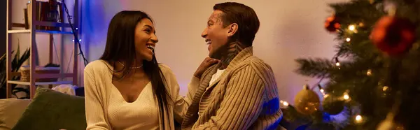 A couple enjoys a heartfelt moment filled with laughter and love on Christmas night. — Stock Photo