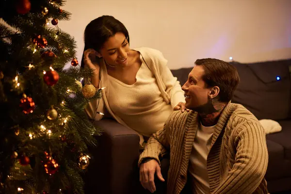 A loving couple enjoys each others company while celebrating Christmas indoors. — Foto stock