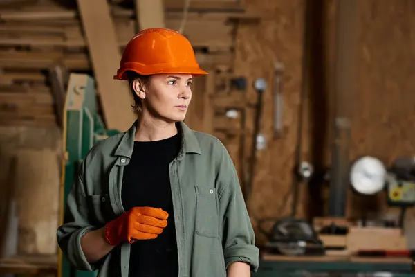 A skilled female carpenter focuses intently on her woodworking project in a well-equipped workshop. — Stock Photo