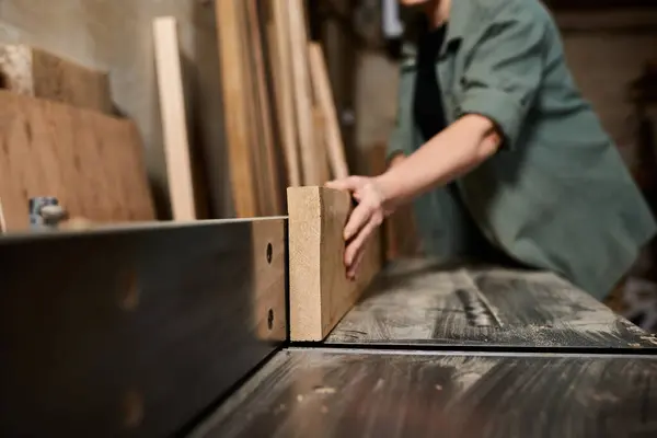 A skilled carpenter focuses intently on crafting wood in her workshop, showcasing craftsmanship and dedication. — Stock Photo