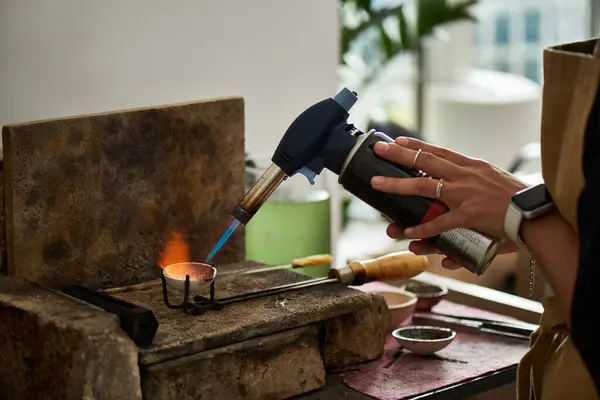 A talented craftsman shapes metal with a torch, showcasing artistry and craftsmanship in the studio. — Stock Photo