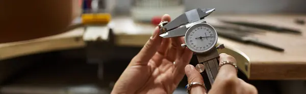A skilled artisan carefully measures exquisite jewelry pieces, showcasing her expertise. — Stock Photo