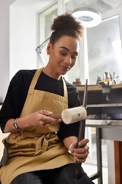 Amidst an inviting workshop, a talented woman meticulously shapes elegant jewelry with care. — Stock Photo