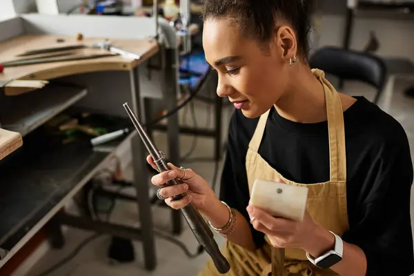 A skilled artisan carefully inspects precious jewels while showcasing her talent in design. — Stock Photo