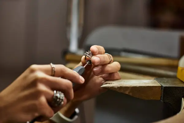 An artisan focuses intensely on creating an exquisite piece of jewelry with precision and care. — Stock Photo