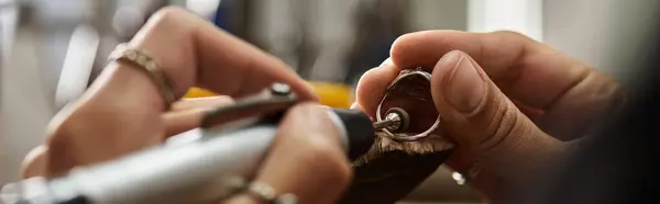 A skilled artisan meticulously works on a stunning piece of jewelry, showcasing her talent. — Stock Photo