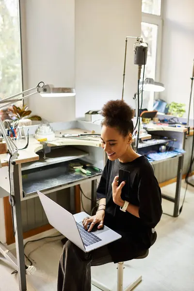 Joyful woman collaborating on a creative project in a stylish workshop filled with tools. — Stock Photo