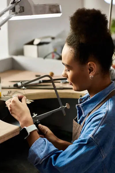 A talented woman designs beautiful jewelry, showcasing her craftsmanship and creativity at work. — Stock Photo