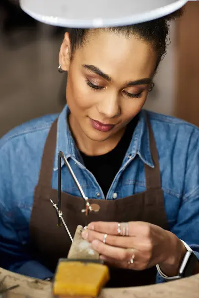 The talented artisan focuses intently on her jewelry creation with precision and passion. — Stock Photo
