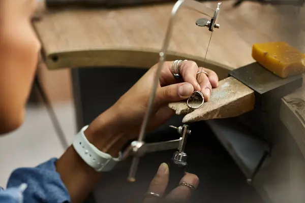 A talented woman focuses on creating a beautiful ring, showcasing her expertise with jewels. — Stock Photo