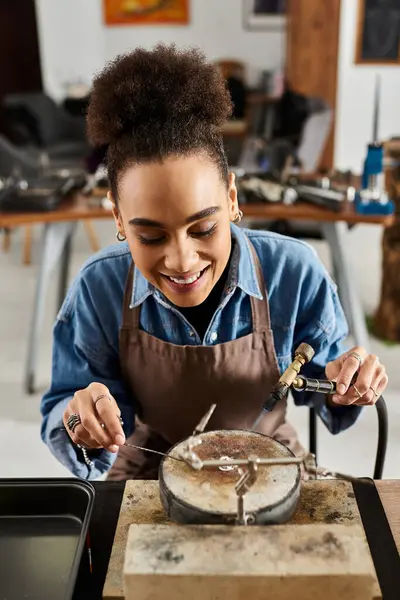 An expert jeweler creates stunning pieces with precision and joy in a lively workspace. — Stock Photo