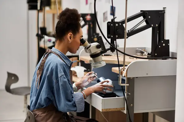 A dedicated professional focuses intently while crafting unique jewelry pieces with precision. — Stock Photo