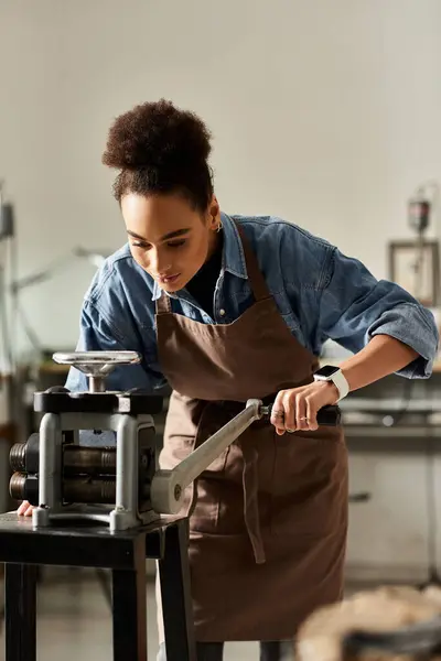 A focused artisan skillfully shapes materials while surrounded by craft tools and equipment. — Stock Photo