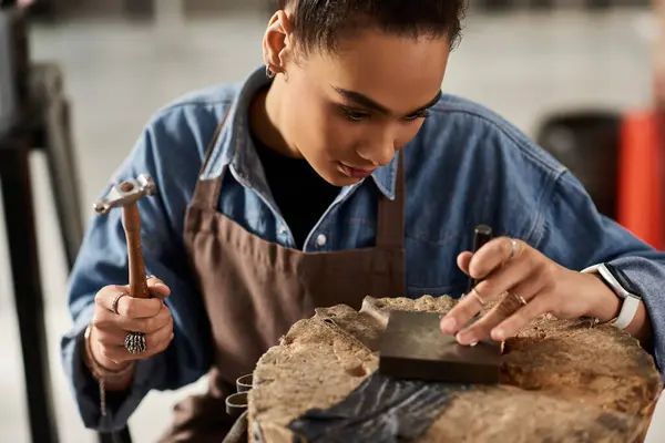A talented jeweler meticulously shapes metal, showcasing artistry and dedication in her craft. — Stock Photo
