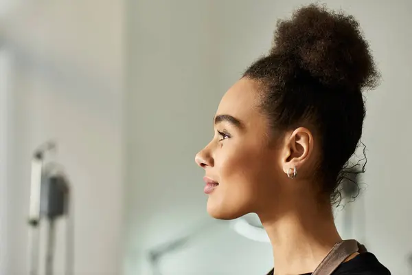 A young woman with a graceful profile looking away in studio. — Stock Photo