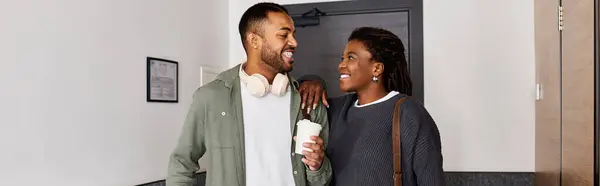 A young couple shares laughter and affection in their hotel room while savoring their vacation. — Stock Photo