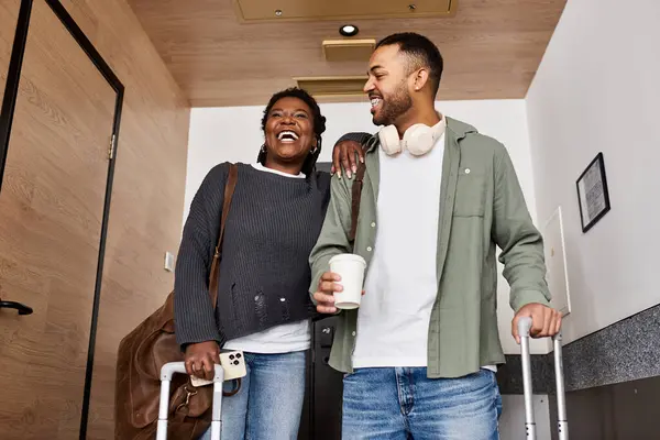A joyful young couple shares laughter and love as they relax in their cozy hotel room. — Stock Photo