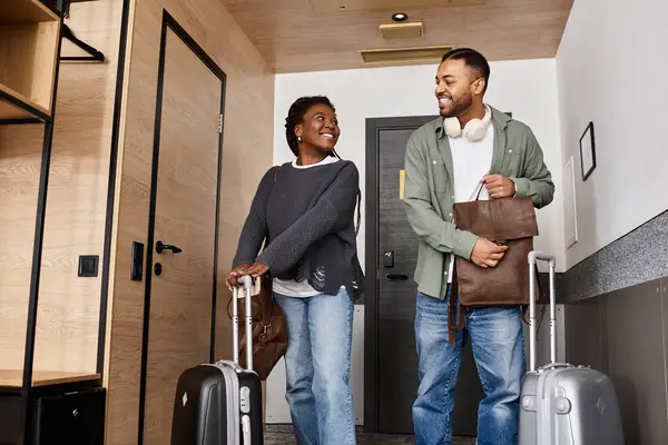 A young couple, in love, arrives at their hotel room, excited for a romantic vacation getaway together. — Stock Photo
