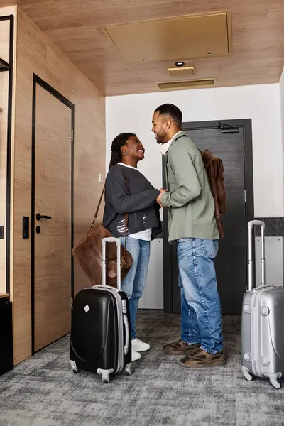 A young couple shares a tender moment in a hotel room, embracing their love and joy during vacation. — Stock Photo