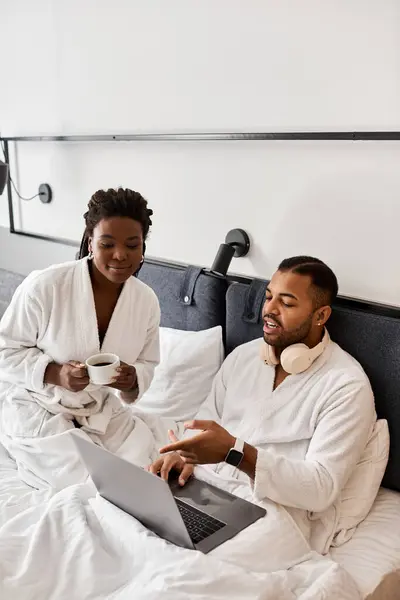 A loving couple relaxes in a hotel room, sharing moments with coffee while on vacation. — Stock Photo