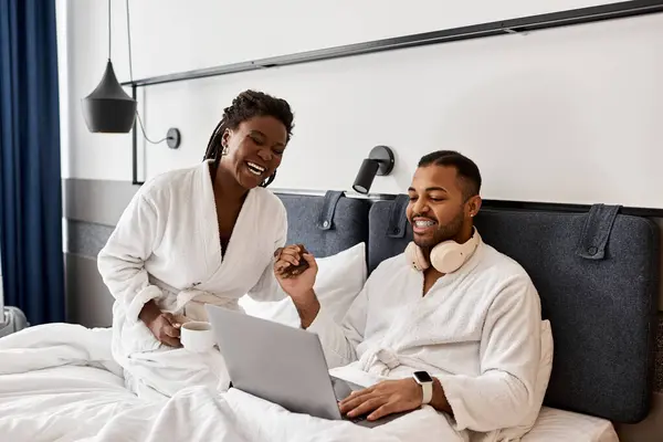 A young couple revels in each others company, sharing laughter while enjoying their hotel getaway. — Stock Photo