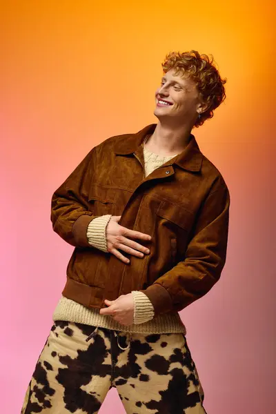 A stylish man showcases holiday fashion with a warm brown jacket and unique pattern pants, exuding confidence and joy in a vibrant setting perfect for Christmas celebrations in 2025. — стоковое фото