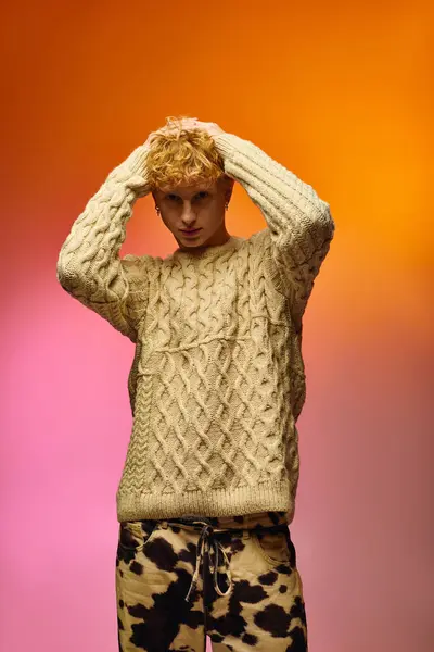 A fashionable man presents a creative holiday outfit featuring a cozy cable knit sweater paired with playful patterned pants. This striking visual captures the festive spirit of Christmas 2025. — Stock Photo