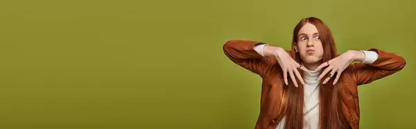 Young man with striking long red hair showcases a range of emotions against a green backdrop. — Stock Photo