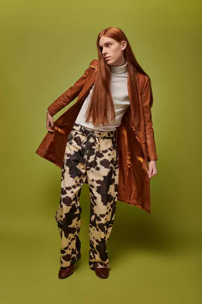 Young man with long red hair showcases flair and emotion in a unique fashion setting. — Stock Photo