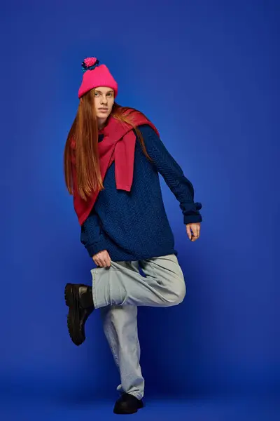 Young man displays deep emotions in stylish winter clothes and a vibrant hat. — Stock Photo