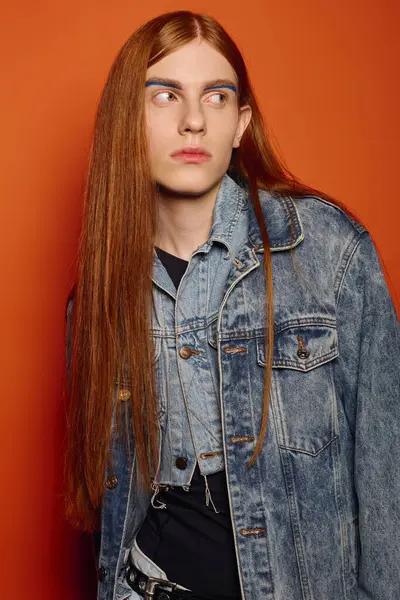 Young man with long red hair reflects deep emotions while standing in front of a bright backdrop — Stock Photo