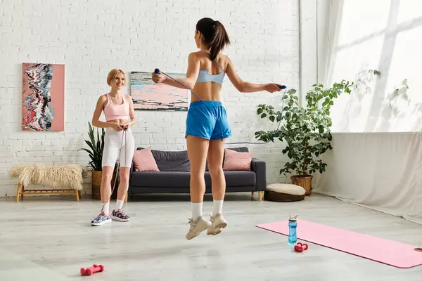 Two women share a joyful workout at home, celebrating love and fitness together. — Stock Photo