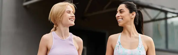 Two young women enjoy a sunny day, smiling and sharing happy moments together outdoors. — Stock Photo