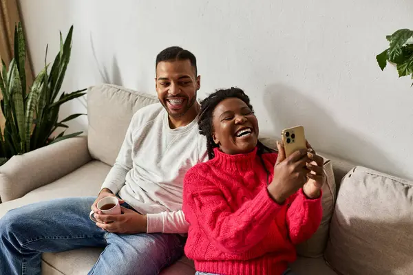 A happy African American couple enjoys quality time together on a winter day, laughing and bonding. — Stock Photo