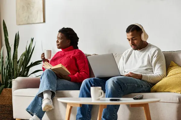 Engaged in quality time, a joyful couple sits together, savoring winter indoors with warmth. — Stock Photo