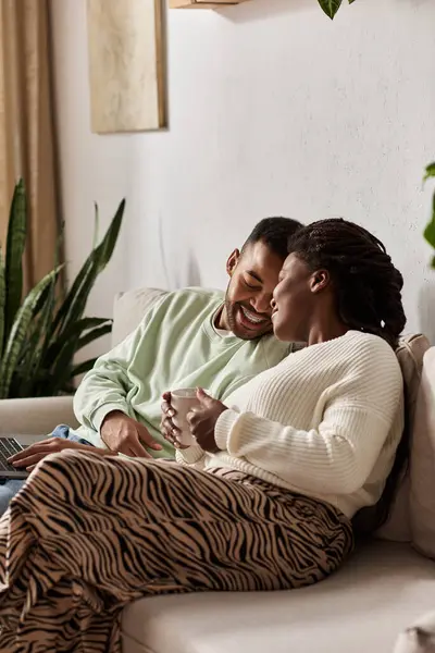 A happy couple enjoys each others company while wrapped in warmth at home during winter. — Stock Photo
