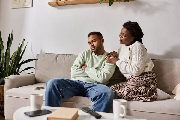 African American couple wearing cozy sweaters during winter, woman calming her man — Stock Photo
