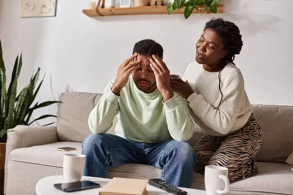 Couple enjoys their time together at home in cozy sweaters, sharing love and support. — Stock Photo