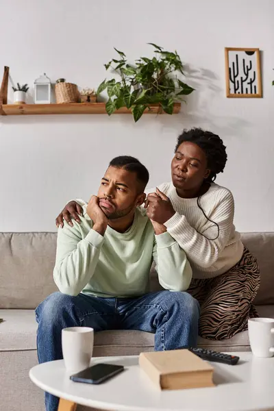 African American couple wearing cozy sweaters during winter, woman comforting her sad partner — Stock Photo